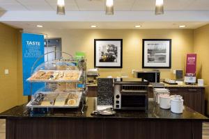 a bakery with a counter with pastries on it at Hampton Inn Superior Duluth, Wi in Superior
