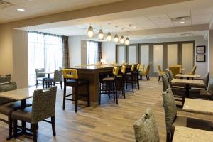 a restaurant with chairs and tables and a bar at Hampton Inn Superior Duluth, Wi in Superior