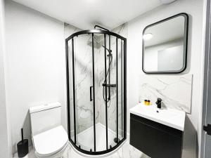 a bathroom with a shower and a sink at Argo Hotel - Kings Cross in London