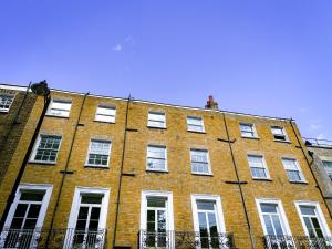 a large red brick building with white windows at Argo Hotel - Kings Cross in London