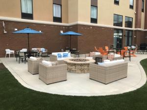 a patio with chairs and tables and umbrellas at Hampton Inn & Suites Morgantown / University Town Centre in Morgantown