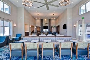 a meeting room with tables and chairs in a lobby at Homewood Suites By Hilton New Orleans West Bank Gretna in Gretna