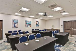a conference room with tables and blue chairs at Homewood Suites By Hilton New Orleans West Bank Gretna in Gretna