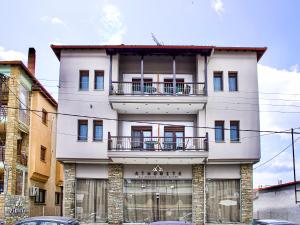 a white building with a balcony on top of it at ATHONITE all seasons luxury suites in Ierissos