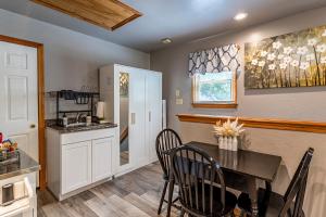 a kitchen and dining room with a table and chairs at Sea Cave, OBX gem, private studio, couple's nest! in Kill Devil Hills