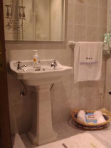 a bathroom with a sink and a basket of towels at Merzuq House in Birżebbuġa