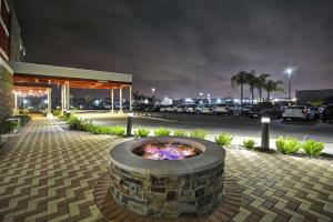 a fire pit in front of a parking lot at night at Home2 Suites by Hilton Brownsville in Brownsville
