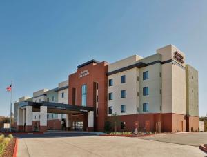a hotel building with a parking lot in front of it at Hampton Inn & Suites Sacramento at CSUS in Sacramento
