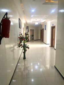 a hallway with a vase of flowers in a building at Hotel Residence Ami Bamba in Sali Nianiaral