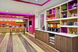 a store with purple walls and wooden shelves at Home2 Suites By Hilton Oklahoma City Airport in Oklahoma City