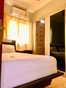 Кровать или кровати в номере Hotel Residence Ami Bamba