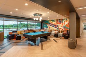 a billiard room with a pool table and chairs at Tru by Hilton Garland Richardson in Garland