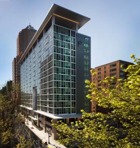 a tall building with glass windows in a city at The Porter Portland, Curio Collection By Hilton in Portland