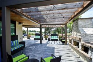 an outdoor patio with chairs and a fireplace at Home2 Suites by Hilton Atlanta Norcross in Norcross