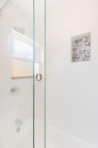 a shower with a glass door in a bathroom at Beach Home W AC- 5 BR - Free Parking - EV Charge in San Diego