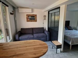 a living room with a couch and a table at Mas d'Alivon in Arles