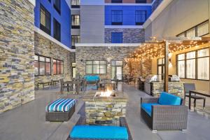 a lobby with a fire pit in a building at Homewood Suites By Hilton Rocky Mount in Rocky Mount