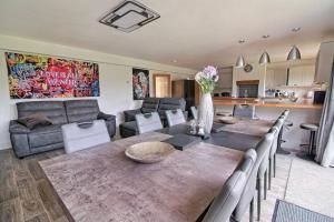 a living room with a table and chairs and a couch at Luxury Air Conditioned 6 Bedroom Hythe Seaside in Kent