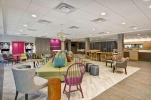 a lobby with a couch and chairs and tables at Home2 Suites by Hilton Kansas City KU Medical Center in Kansas City