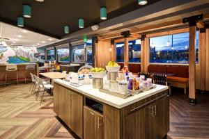 a restaurant with a counter with food on it at Tru By Hilton Salt Lake City Airport in Salt Lake City