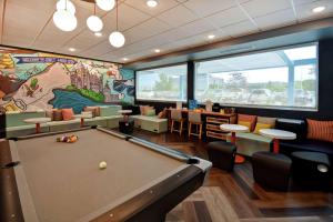 a billiard room with a pool table and a mural at Tru By Hilton Salt Lake City Airport in Salt Lake City