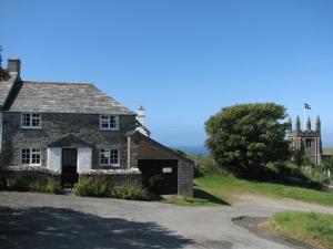 an old stone house on the side of a road at Barton Cottage in Bude