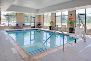 a large swimming pool in a hotel lobby at Hampton Inn & Suites Chicago-Burr Ridge in Burr Ridge