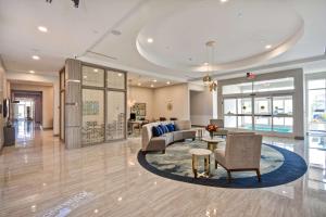 a lobby with a couch and chairs and a table at Homewood Suites by Hilton Conroe in Conroe