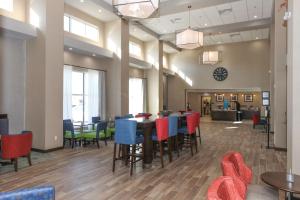 a dining room with tables and chairs in a building at Hampton Inn & Suites Lafayette in Lafayette