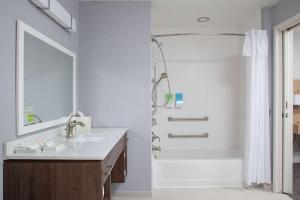 布卢明顿Home2 Suites by Hilton Bloomington的带水槽和淋浴的白色浴室