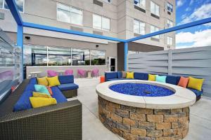 a patio with a fire pit in front of a building at Tru By Hilton North Platte in North Platte