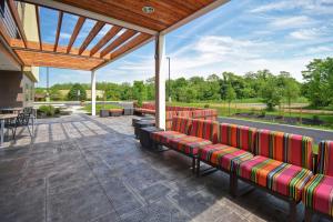 a group of benches sitting on a patio at Home2 Suites Mechanicsburg in Mechanicsburg