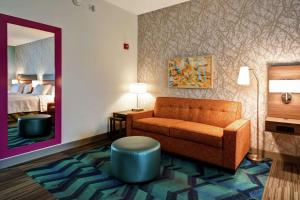 a hotel room with a couch and a bed at Home2 Suites Mechanicsburg in Mechanicsburg