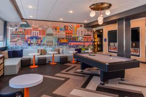 a gaming room with a pool table and a mural at Tru By Hilton Little Rock West in Little Rock