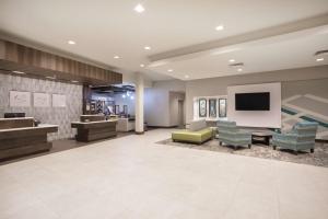 a lobby with a waiting area with a tv and chairs at Hilton Garden Inn Omaha Aksarben Village in Omaha