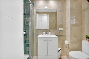a bathroom with a white sink and a toilet at Nice studio Bart 50 meters from Playa Las Vistas in Arona +32 photos
