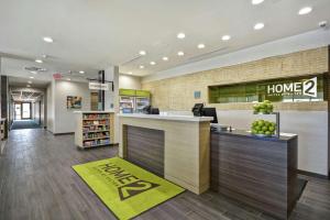 a lobby of a store with a home sign on the wall at Home2 Suites By Hilton Texas City Houston in Texas City +42 photos