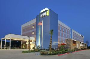 a hotel with a sign on the side of a building at Home2 Suites by Hilton Mobile I-65 Government Boulevard in Mobile