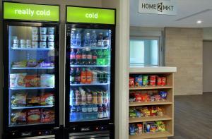 two refrigerators in a store with drinks and food at Home2 Suites by Hilton Mobile I-65 Government Boulevard in Mobile