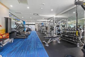 a gym with treadmills and machines in a room at Wonderful 2BR Condo @Crystal City With Gym in Arlington