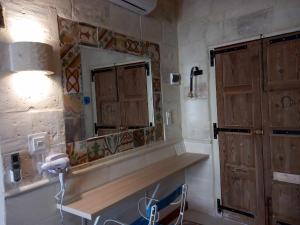 a bathroom with a sink and a mirror at The 1930's Maltese Residence in St. Paul's Bay