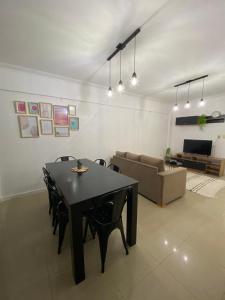 a living room with a table and chairs and a couch at Departamento Centro in Santiago del Estero