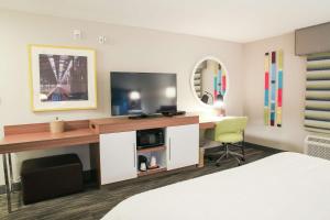 a hotel room with a desk with a tv and a bed at Hampton Inn & Suites Mount Laurel/Moorestown in Mount Laurel