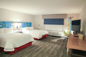 a hotel room with two beds and a flat screen tv at Hampton Inn & Suites Mount Laurel/Moorestown in Mount Laurel