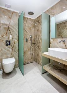 een badkamer met een douche, een toilet en een wastafel bij Otium Studios in Limenaria