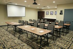 a conference room with tables and chairs and a screen at Hampton Inn & Suites Mount Laurel/Moorestown in Mount Laurel