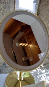 a reflection of a room in a mirror at I Loft Viana in Viana do Castelo