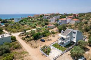 an aerial view of a house with the ocean in the background at Otium Studios in Limenaria