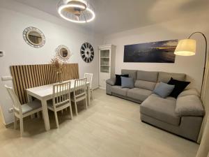 een woonkamer met een bank en een tafel bij Apartaments L’ARC in Palafrugell
