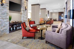 a lobby with chairs and a couch and a table at Hilton Garden Inn Waco in Waco
